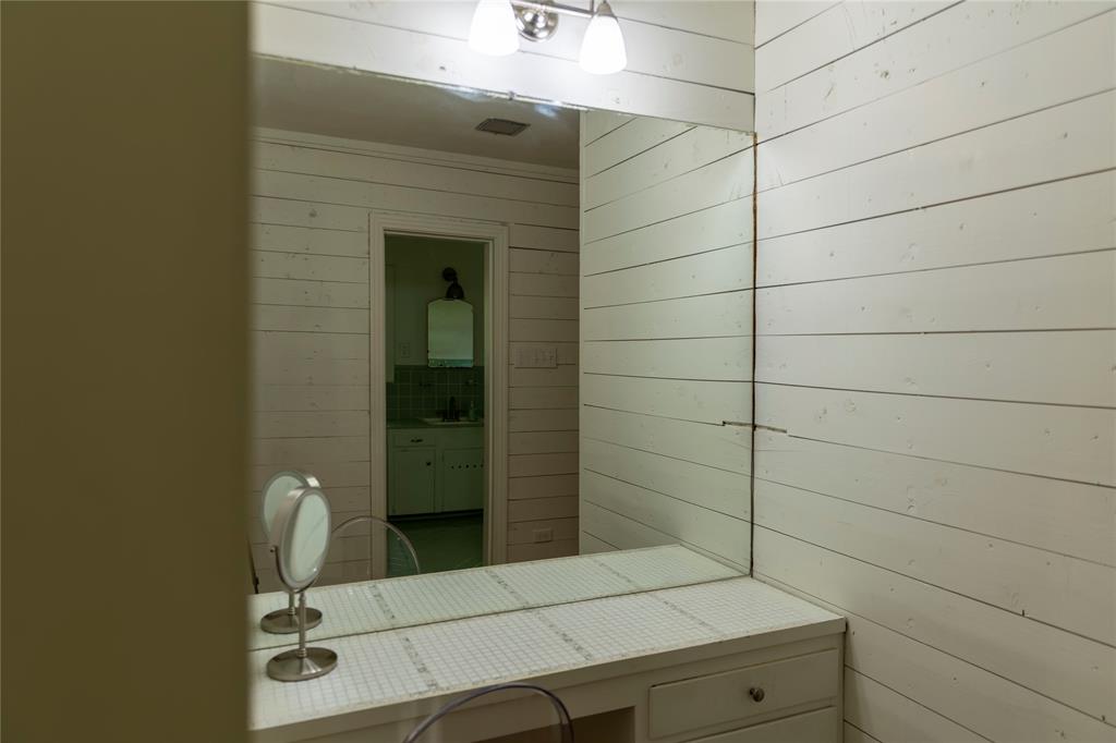 3228 Colcord Avenue Waco, TX 76707 - Photo 18 of 29 Shiplap wall paneling complementing a built-in vanity with a tiled countertop and integrated mirror