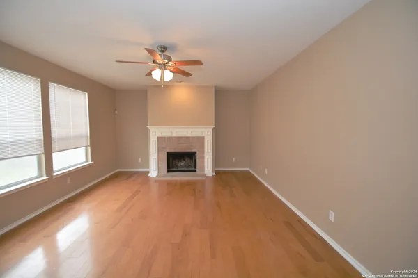 a view of empty room with a fireplace and fan