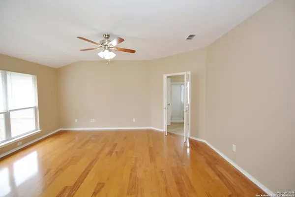 wooden floor in an empty room with a window