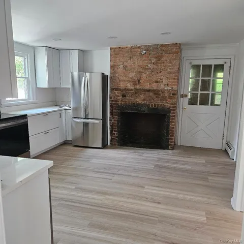 a kitchen with a refrigerator and a stove top oven