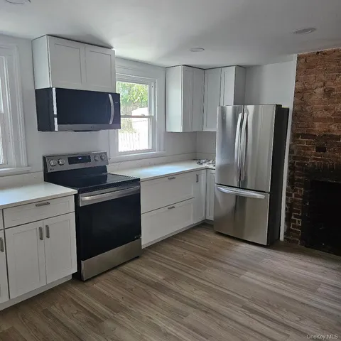 a kitchen with stainless steel appliances a refrigerator stove and microwave