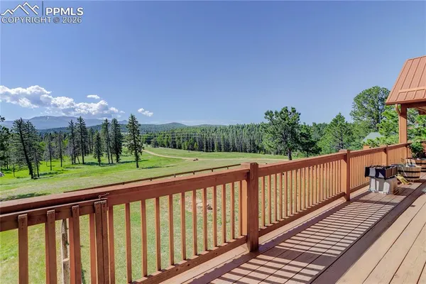 a view of a balcony with wooden fence