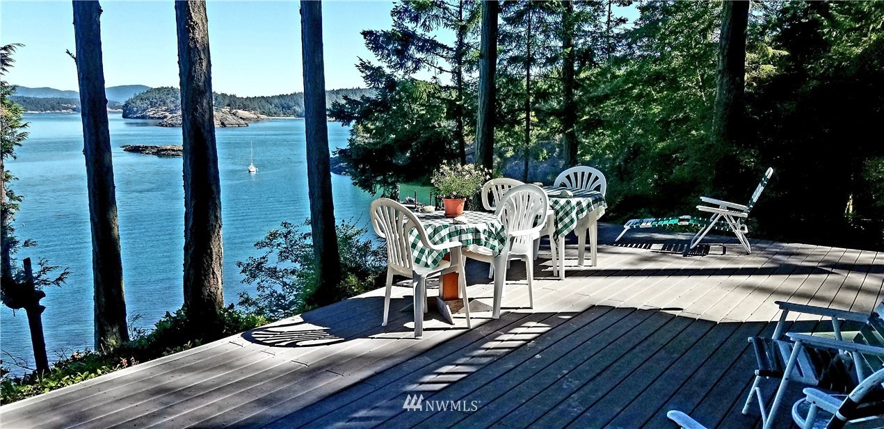 1327 Islandale Road Lopez Island, WA 98261 - Photo 2 of 22 a view of a table and chairs in patio with wooden fence