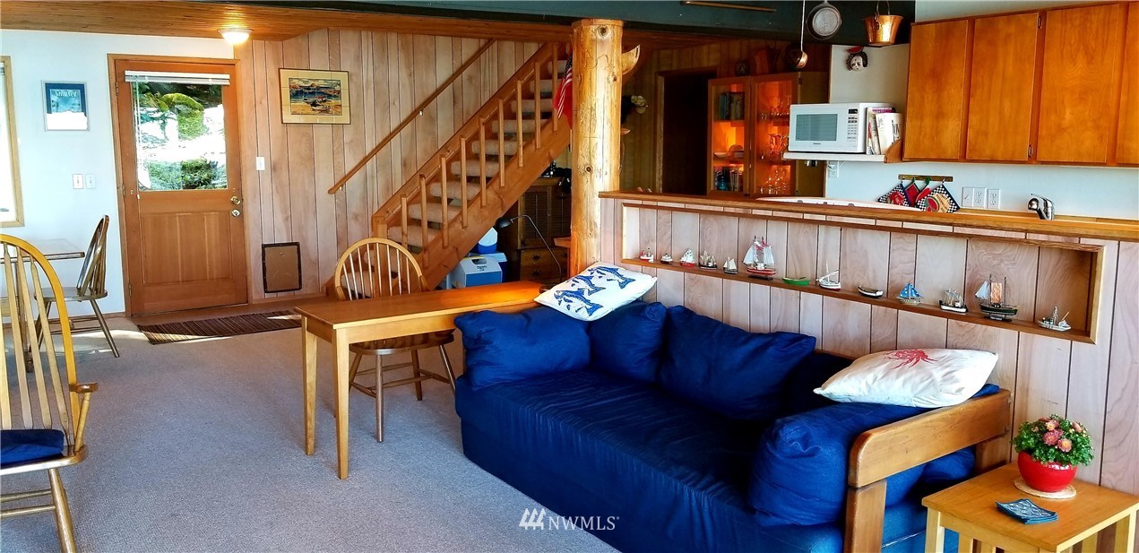 1327 Islandale Road Lopez Island, WA 98261 - Photo 13 of 22 a living room with furniture stairs and a window