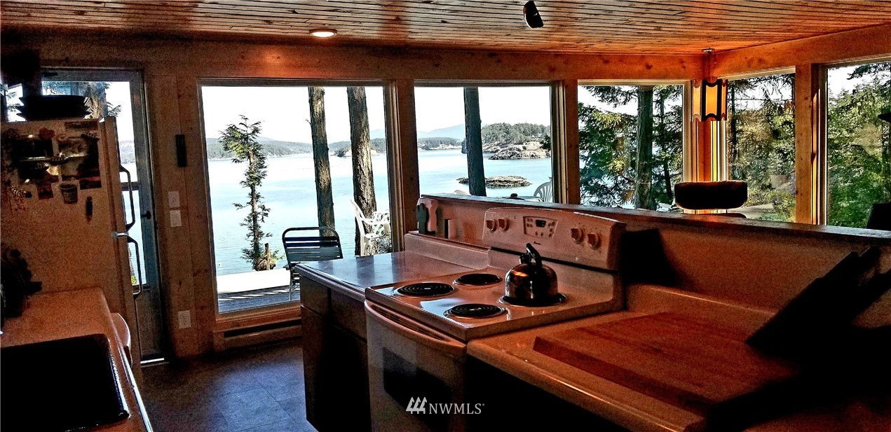 1327 Islandale Road Lopez Island, WA 98261 - Photo 7 of 22 a living room with furniture and large windows