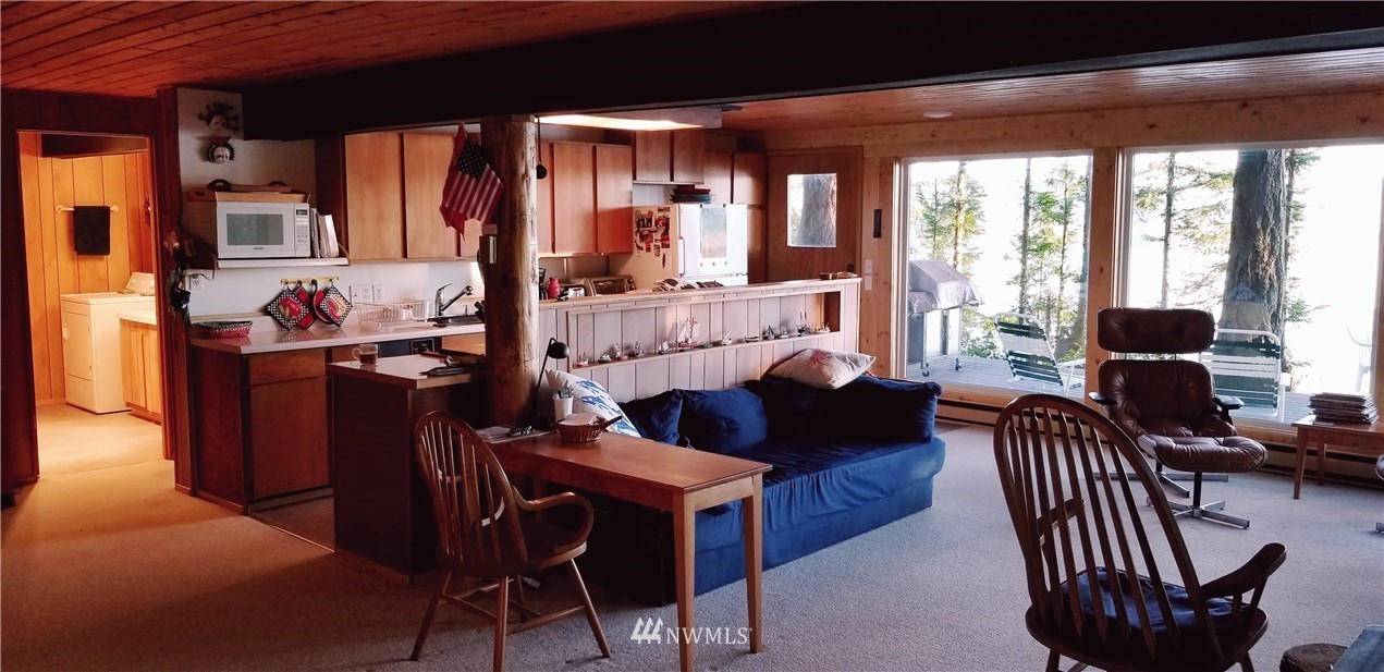 1327 Islandale Road Lopez Island, WA 98261 - Photo 10 of 22 a living room with furniture and a fireplace