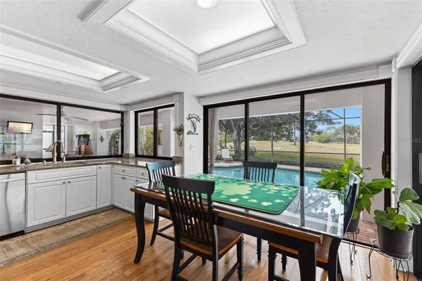 a kitchen with a stove a refrigerator sink dishwasher and wooden cabinets