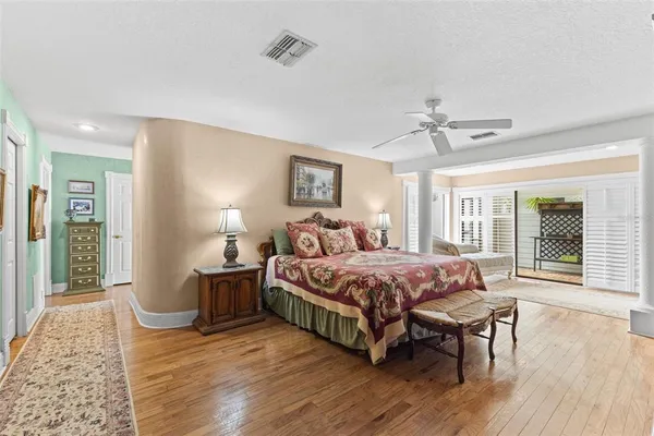 a view of a room with gym equipment and wooden floor