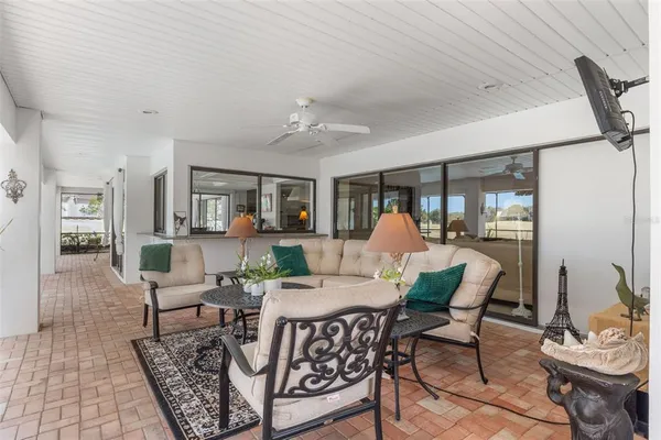 a view of a patio with table and chairs and potted plants