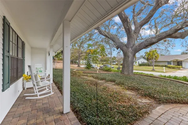 a view of a porch with a chairs and table in a patio