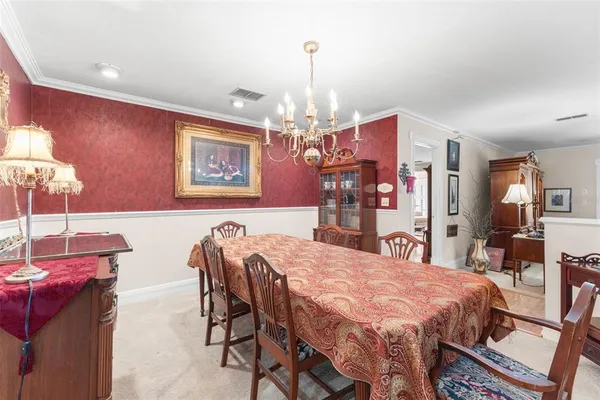 a view of a dining room with furniture and chandelier