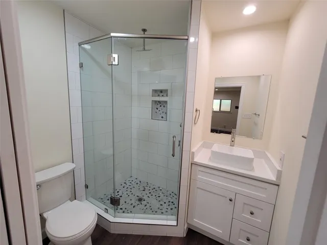 a bathroom with a sink a toilet and shower