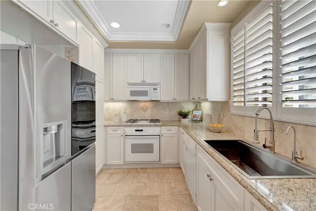 a spacious bedroom with a large bed and a chandelier