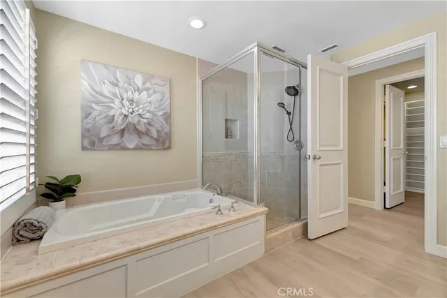 a bathroom with a shower sink vanity mirror and toilet