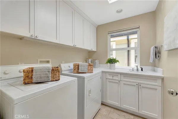 a kitchen with cabinets appliances a sink and a window