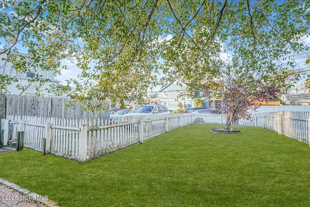 a view of a backyard with sitting area