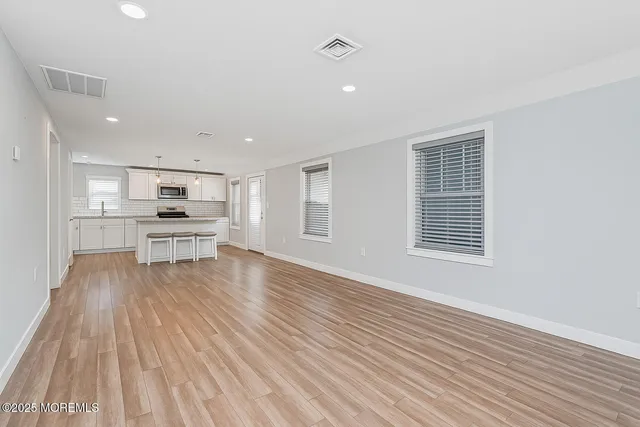 a view of kitchen with wooden floor and window