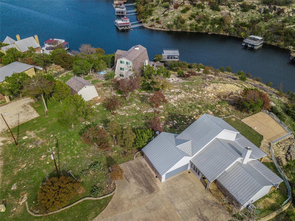 1040 Bluff Creek Point Strawn, TX 76475 - Photo 26 of 30 an aerial view of a house with garden space and lake view