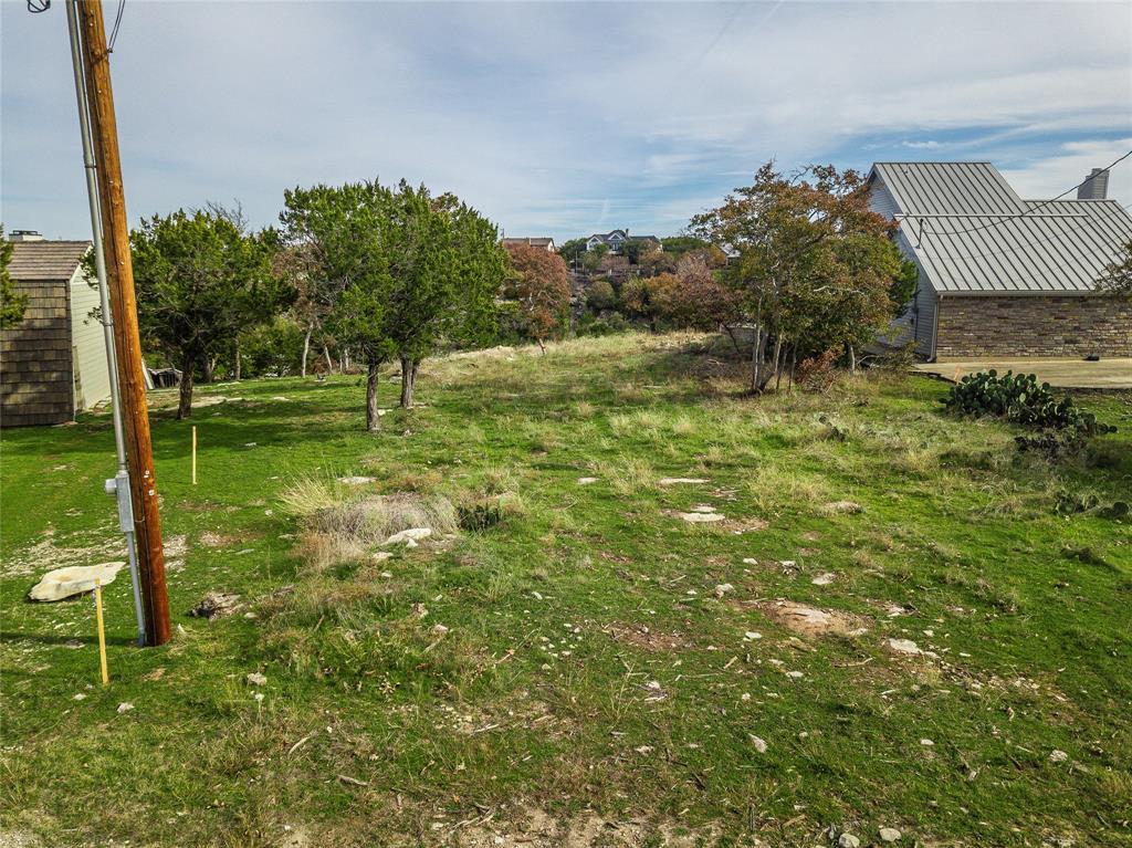 1040 Bluff Creek Point Strawn, TX 76475 - Photo 5 of 30 a backyard of a house with lots of green space and fountain