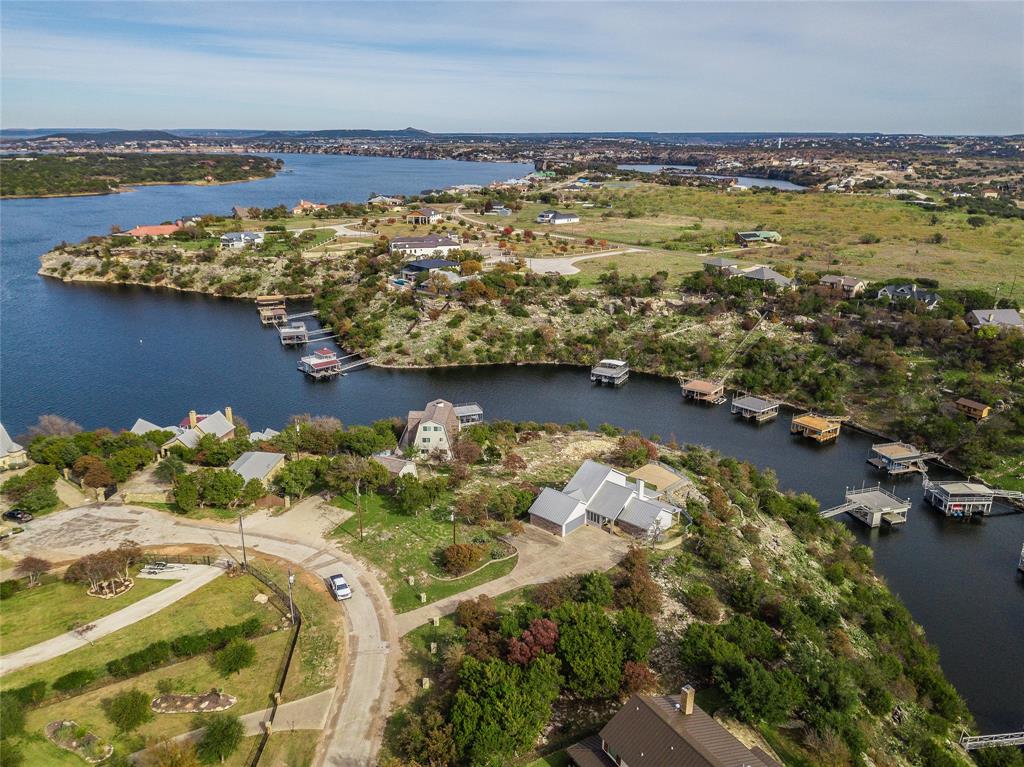 1040 Bluff Creek Point Strawn, TX 76475 - Photo 8 of 30 a view of a lake with a nearby beach