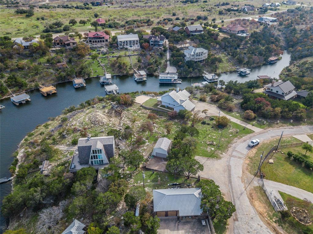 1040 Bluff Creek Point Strawn, TX 76475 - Photo 9 of 30 an aerial view of a house with a yard basket ball court and outdoor seating