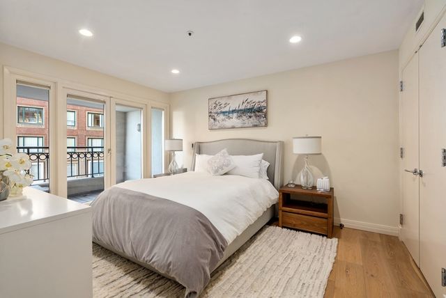 a bedroom with bed and a night stand