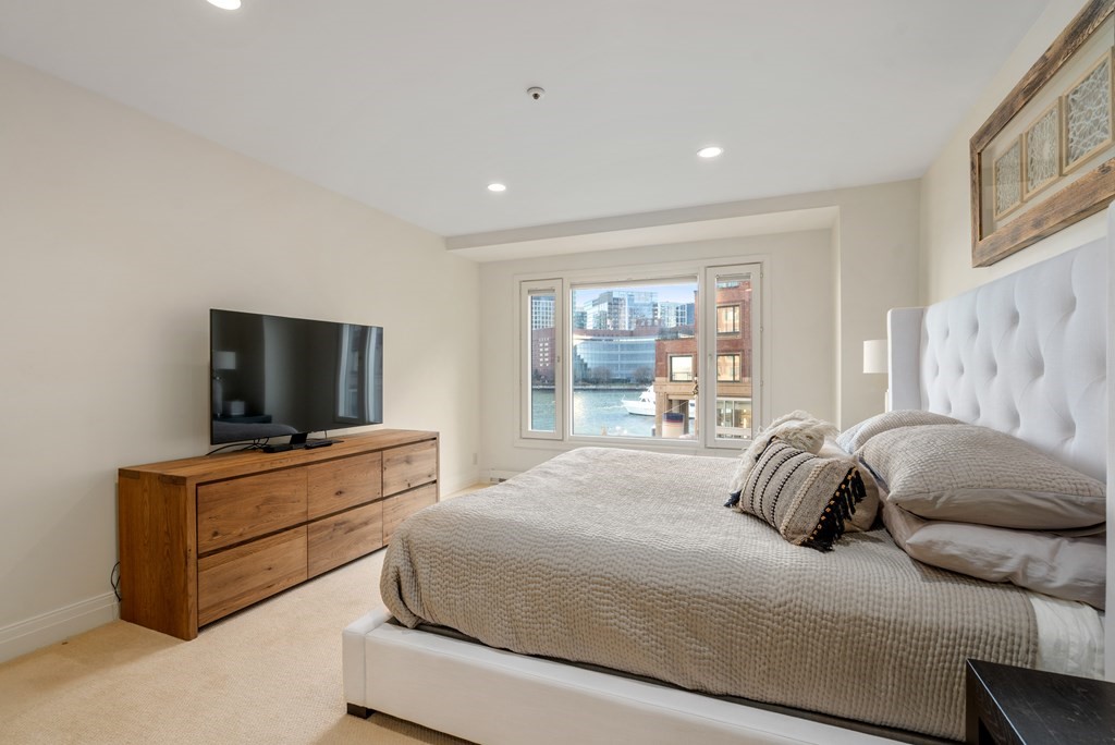 20 Rowes Wharf, Unit 306 Boston, MA 02110 - Photo 8 of 14 a bedroom with a bed and a flat screen tv