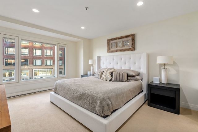 a bedroom with a large bed and a large window