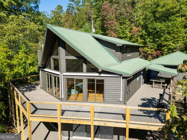 a view of house with trees in the background