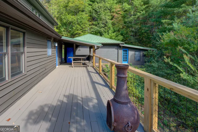 a view of backyard with deck and wooden floor