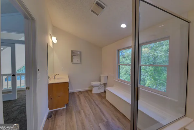 a view of a room with wooden floor and furniture