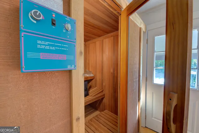 a view of a room that has a door and a window