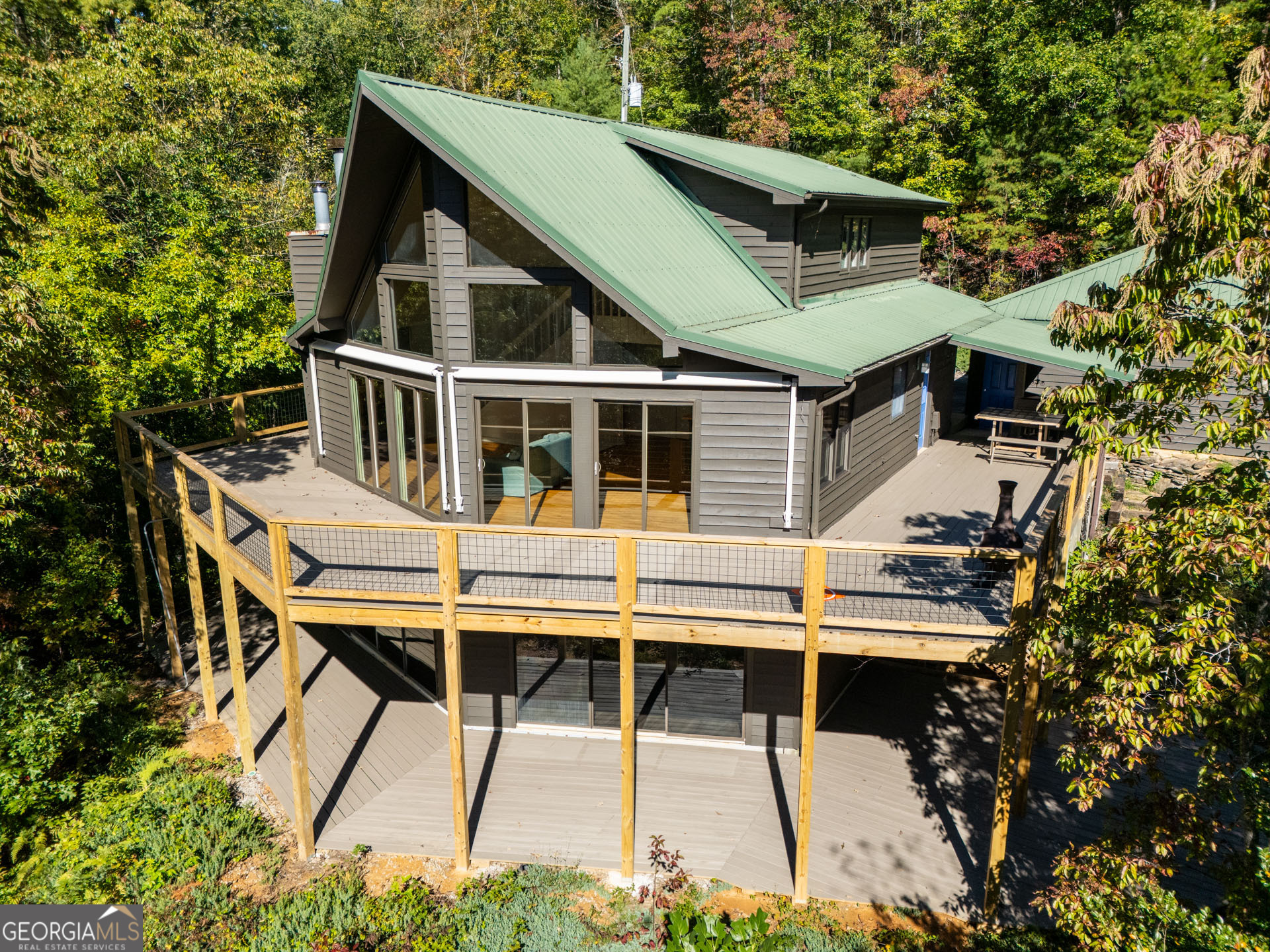 1799 Seed Lake Road Lakemont, GA 30552 - Photo 2 of 42 a roof deck with table and chairs under an umbrella