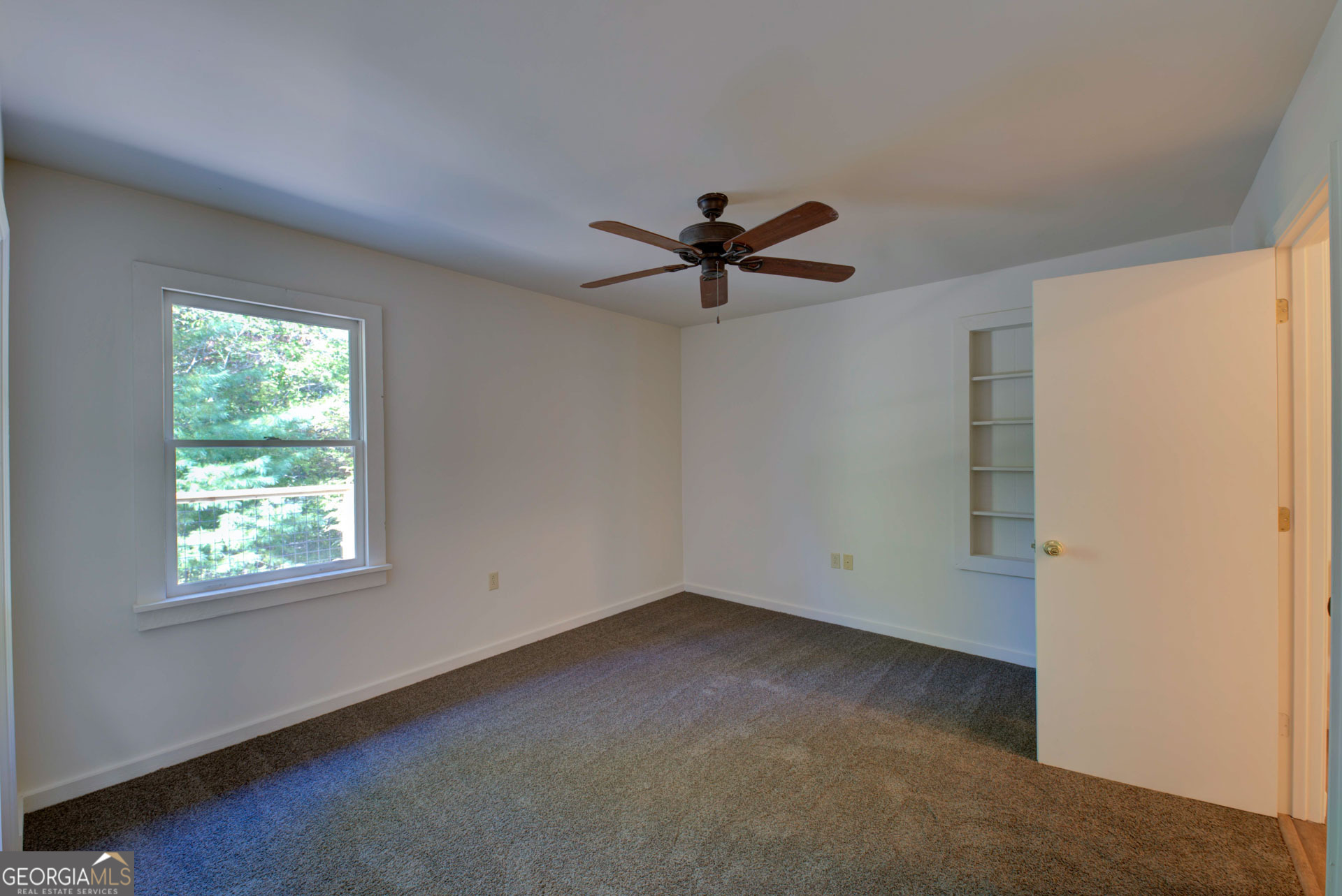 1799 Seed Lake Road Lakemont, GA 30552 - Photo 22 of 42 an empty room with a window and a fan