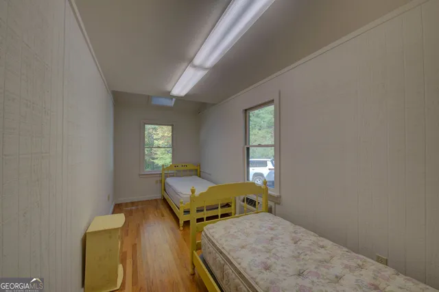 a bedroom with bed and a window