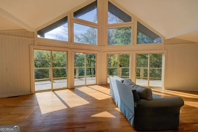 a living room with furniture and large windows