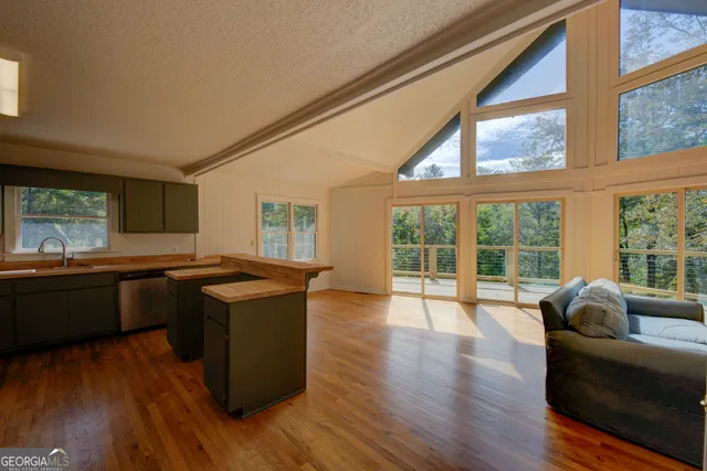 a view of a house with wooden floor and furniture in it
