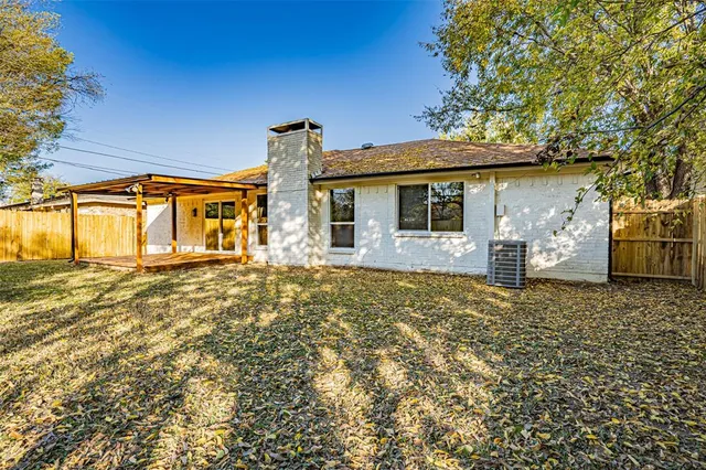 front view of a house with a large tree
