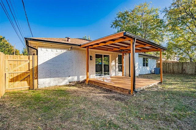 a backyard of a house with table and chairs