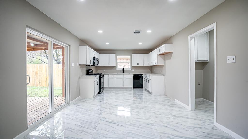 6901 Bennington Drive Watauga, TX 76148 - Photo 19 of 36 a large kitchen with a large window and stainless steel appliances