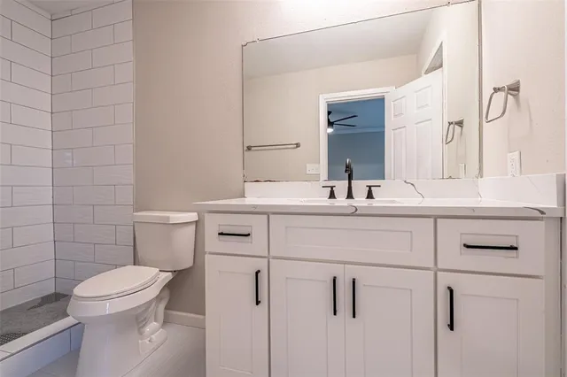 a bathroom with a sink toilet and mirror