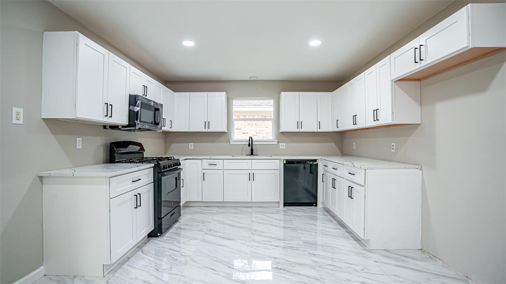 6901 Bennington Drive Watauga, TX 76148 - Photo 22 of 36 a kitchen with granite countertop white cabinets and white appliances