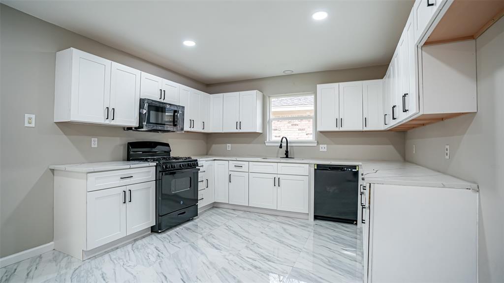 6901 Bennington Drive Watauga, TX 76148 - Photo 23 of 36 a kitchen with cabinets stainless steel appliances a sink and a window