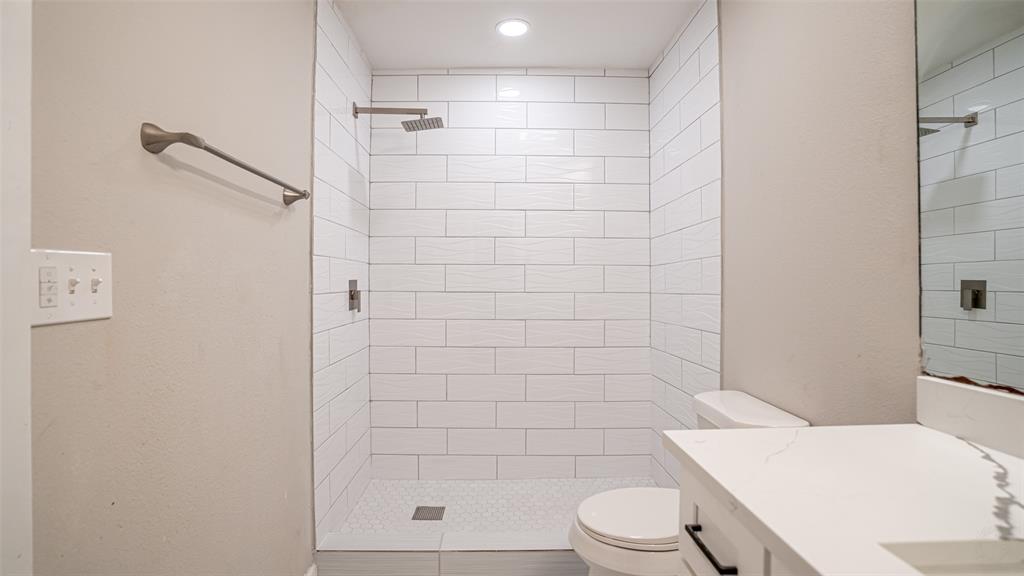 6901 Bennington Drive Watauga, TX 76148 - Photo 27 of 36 a bathroom with a shower a toilet and sink