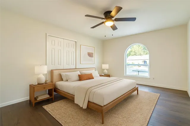 a bedroom with a bed a window and a chandelier