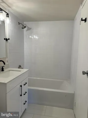 a bathroom with a sink a mirror and a bathtub