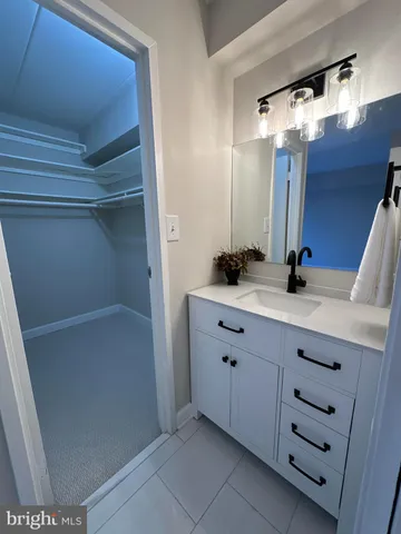 a bathroom with a double vanity sink and mirror