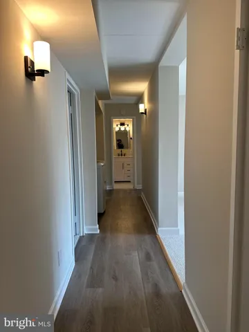 a view of a hallway with wooden floor