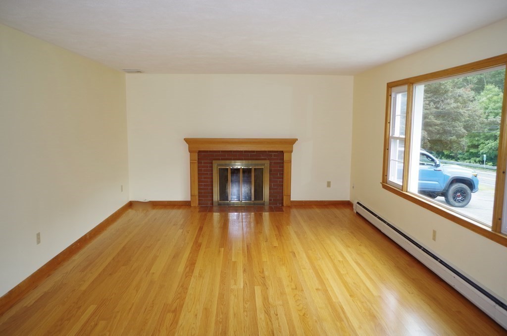 107 Westhampton Road Northampton, MA 01062 - Photo 13 of 22 a view of empty room with wooden floor and fireplace