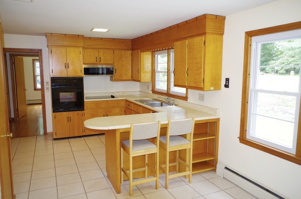 107 Westhampton Road Northampton, MA 01062 - Photo 8 of 22 a dining hall with a large window and kitchen view